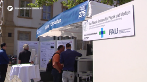 photo of the Market stand shared by AOT-TP and an Max-Planck-Center