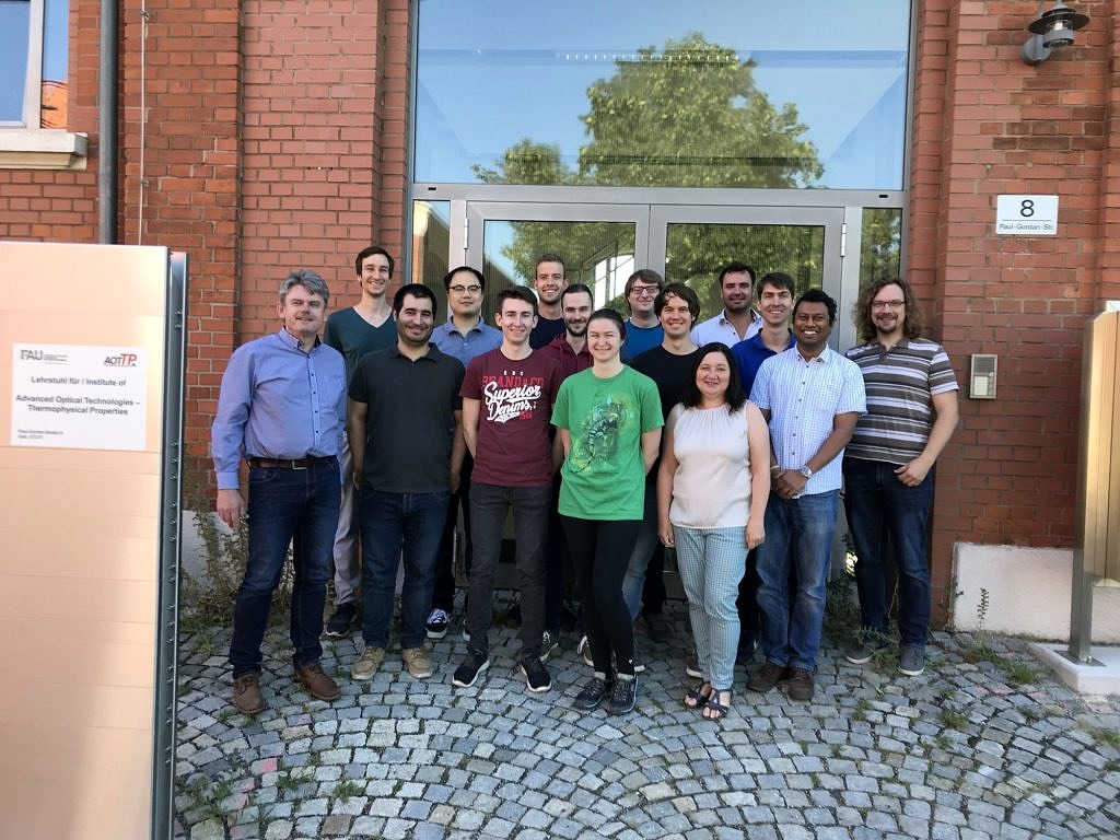 Photograph of AOT-TP team standing in front of the insititute entrance in July 2019