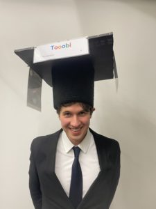 photo of Tobias Klein with his doctoral hat after the successful thesis defense