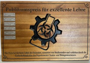 photograph of the wooden certificate for the teaching audience award won by Thomas Koller