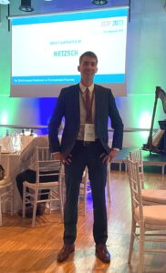 Photo showing Thomas M. Koller in front of the presentation screen after he has received the award